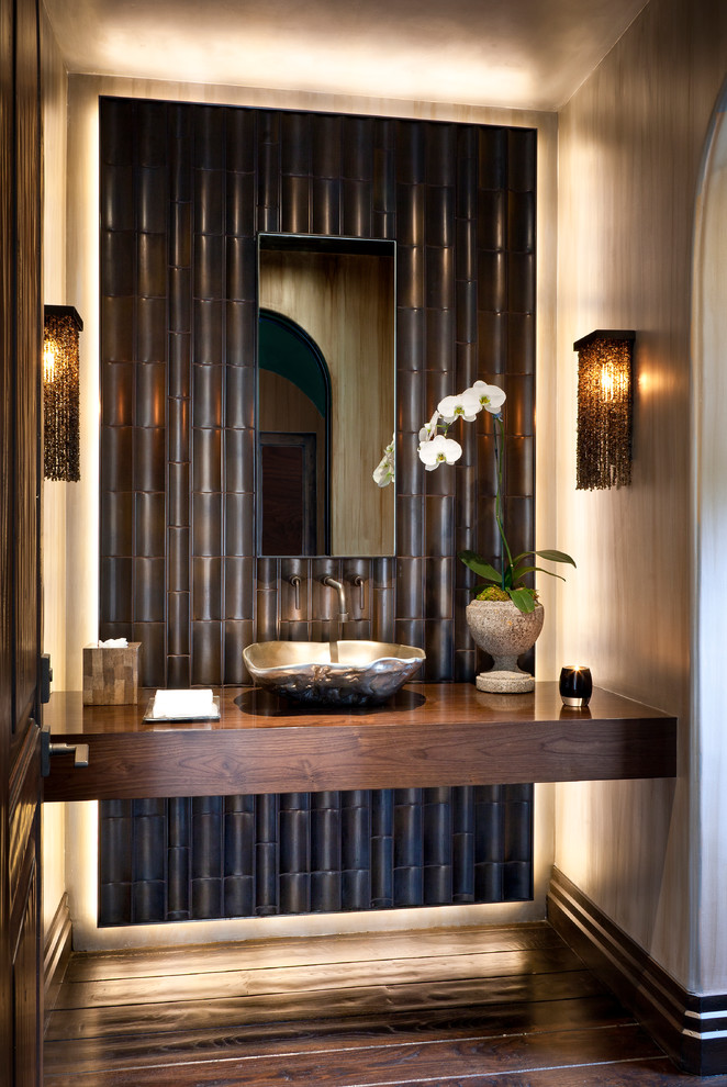 Design ideas for a tropical powder room in Los Angeles with a vessel sink, wood benchtops and brown benchtops.