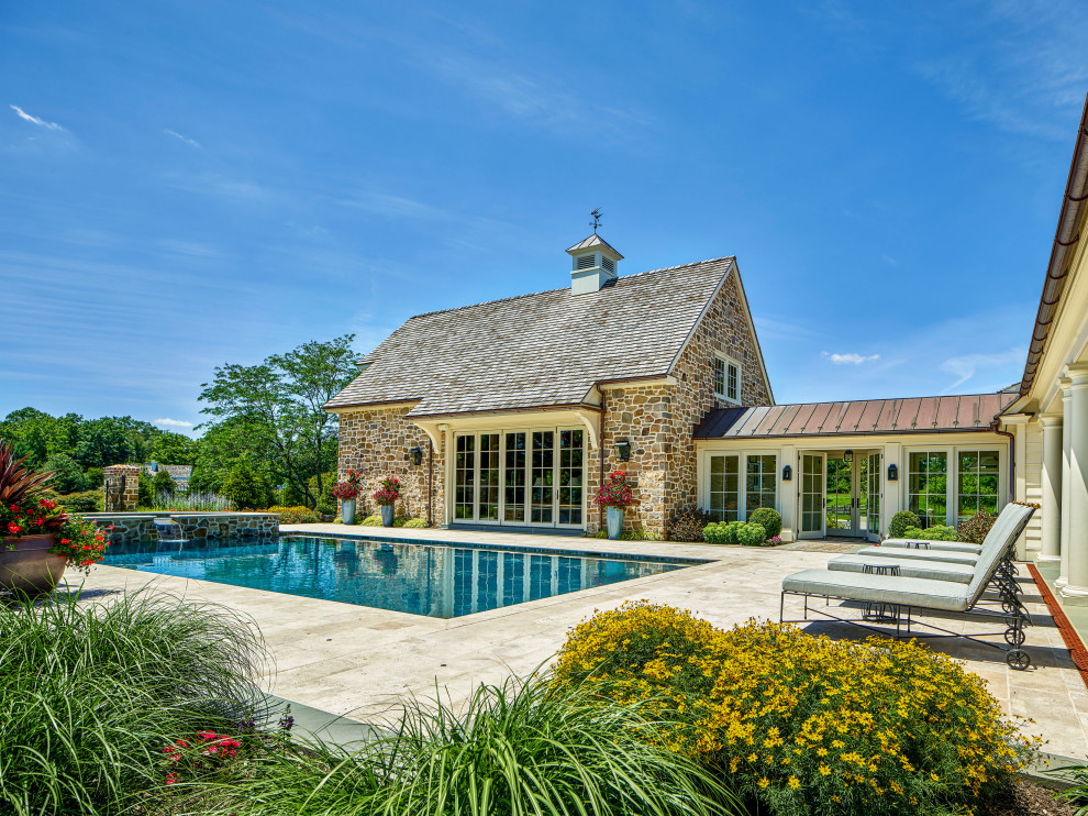 Inspiration for a timeless backyard stone and rectangular pool remodel in Philadelphia