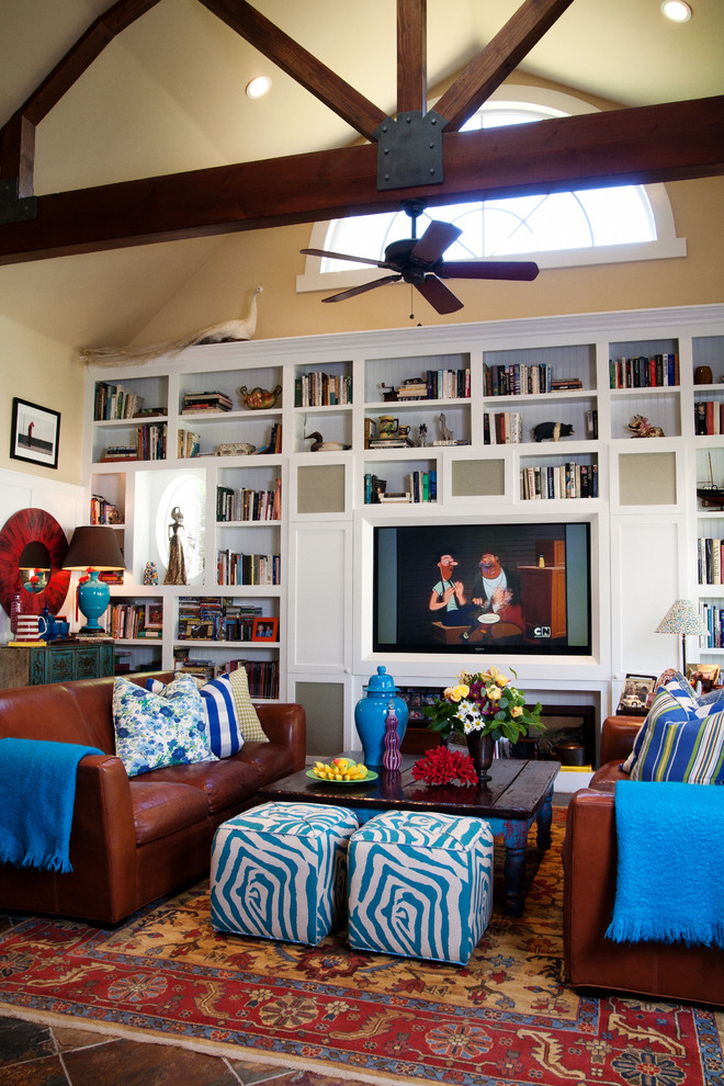 Inspiration for an eclectic family room in Los Angeles with a library, beige walls and a built-in media wall.