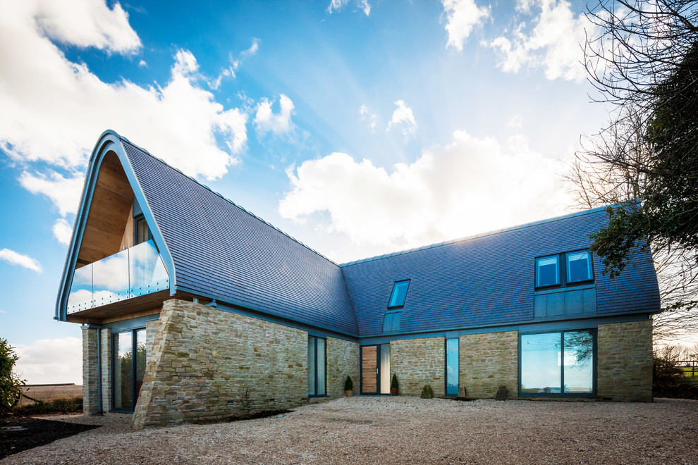 Contemporary two-storey exterior in Oxfordshire with stone veneer and a gable roof.