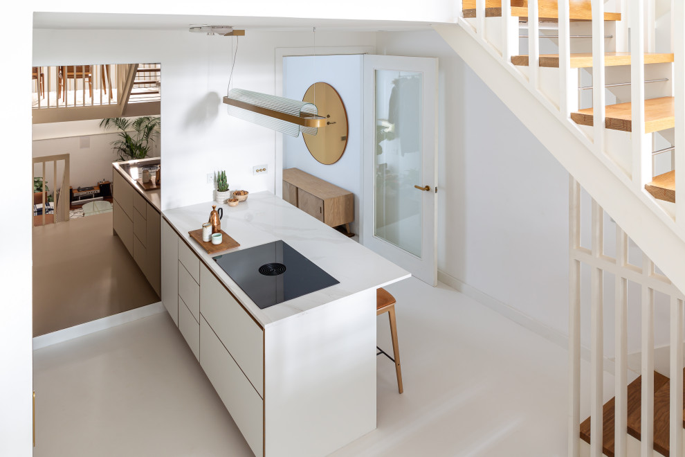 Small scandinavian single-wall kitchen in London with flat-panel cabinets, white cabinets, composite countertops, white splashback, white appliances and white worktops.