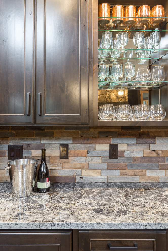 Photo of a large country single-wall wet bar in Portland with a drop-in sink, shaker cabinets, brown cabinets, quartzite benchtops, multi-coloured splashback, ceramic splashback, dark hardwood floors, brown floor and multi-coloured benchtop.