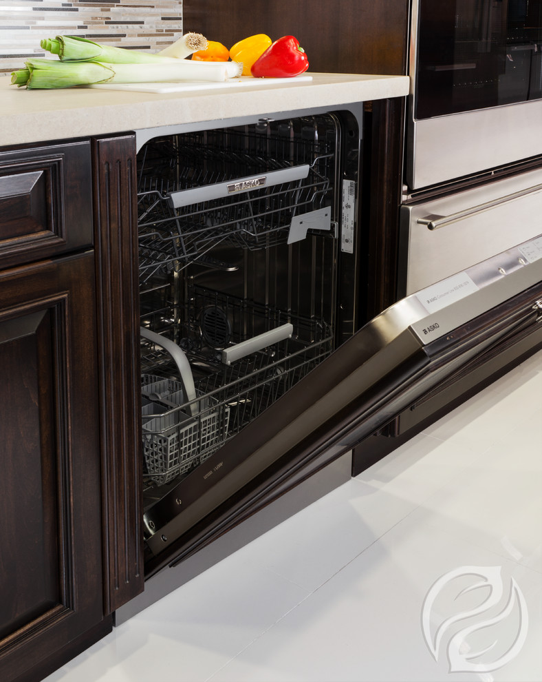 Open concept kitchen - mid-sized transitional l-shaped porcelain tile open concept kitchen idea in Chicago with an undermount sink, raised-panel cabinets, dark wood cabinets, quartz countertops, multicolored backsplash, glass tile backsplash, stainless steel appliances and an island