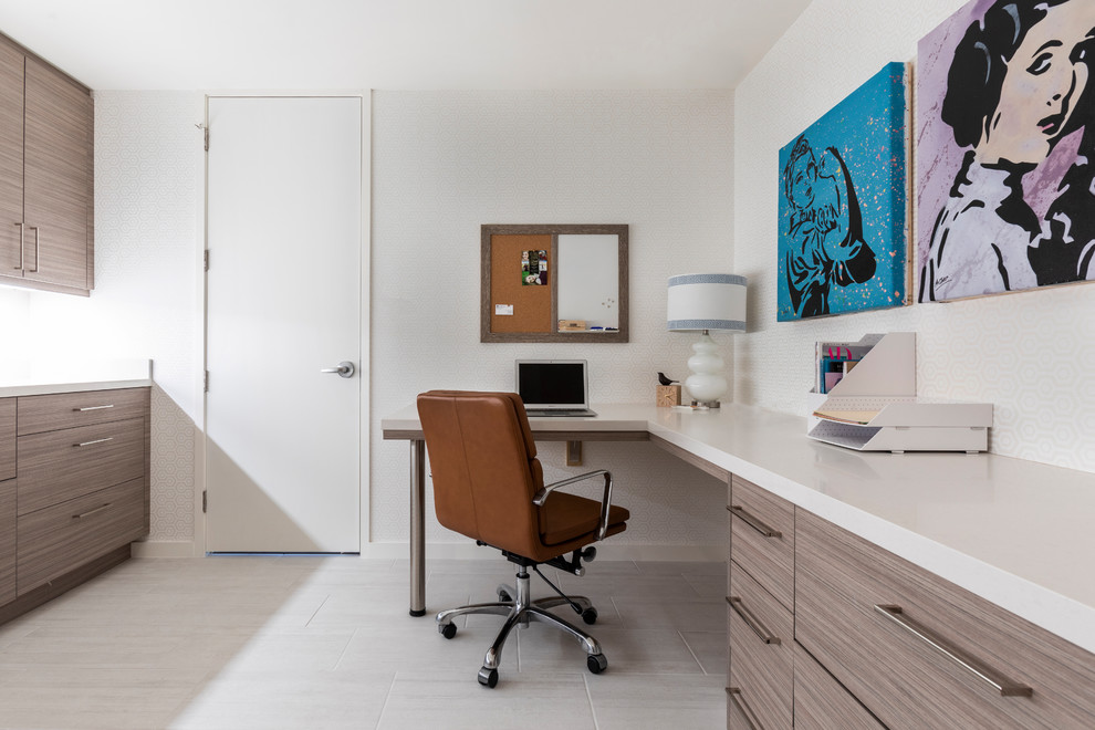 Contemporary home office in Houston with white walls, a built-in desk and grey floor.
