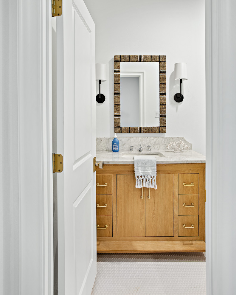 Photo of an expansive traditional family bathroom in Dallas with shaker cabinets, light wood cabinets, an alcove bath, a shower/bath combination, a two-piece toilet, white tiles, white walls, porcelain flooring, white floors, a shower curtain, grey worktops, a single sink, a freestanding vanity unit and a submerged sink.