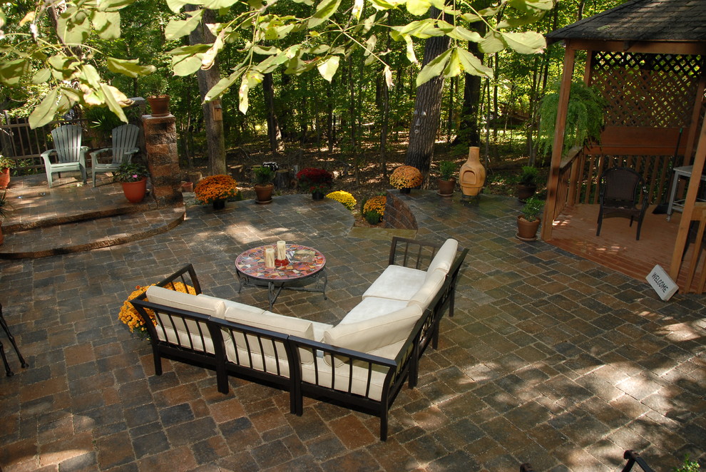 Example of a mountain style backyard concrete paver patio design