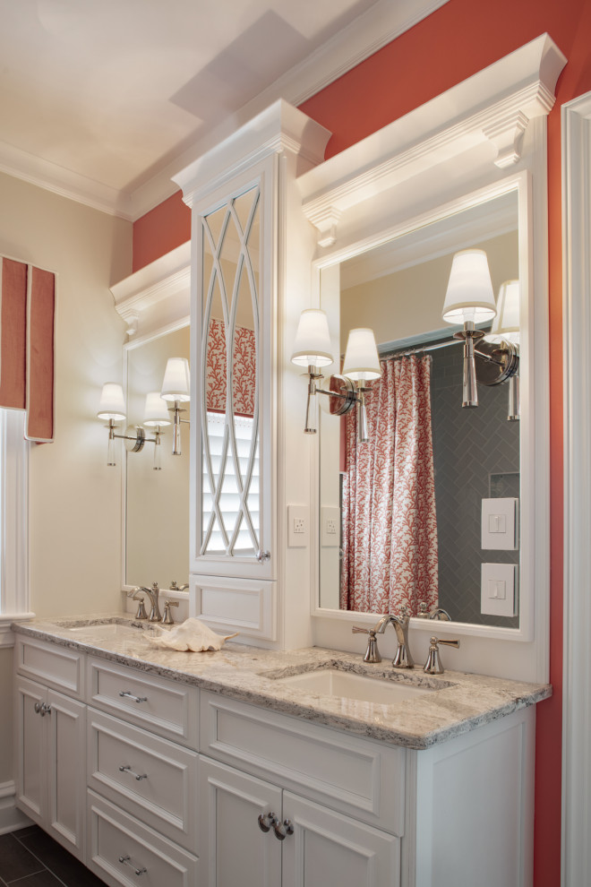 Inspiration for a large transitional 3/4 bathroom in Charleston with white cabinets, a shower/bathtub combo, gray tile, glass tile, porcelain floors, an undermount sink, engineered quartz benchtops, grey floor, a shower curtain, grey benchtops, recessed-panel cabinets, orange walls, a double vanity and a built-in vanity.