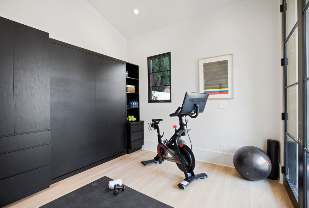 Design ideas for a mid-sized transitional multipurpose gym in Los Angeles with white walls, light hardwood floors and beige floor.