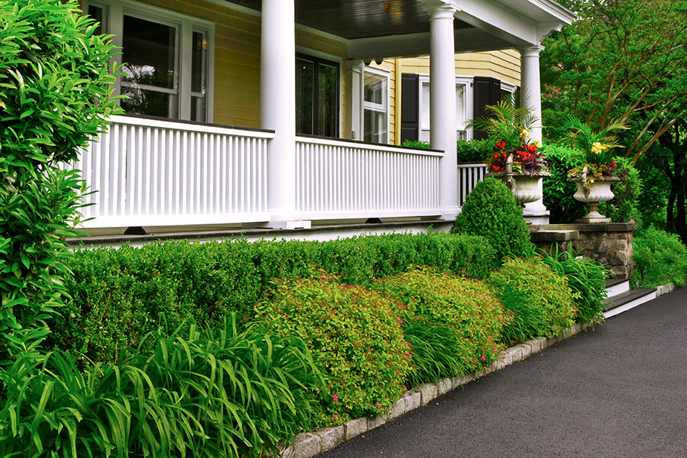Inspiration for a large victorian partial sun front yard driveway in New York with decking.