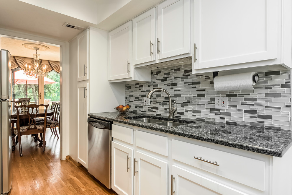Photo of a small transitional galley eat-in kitchen in Columbus with white cabinets.