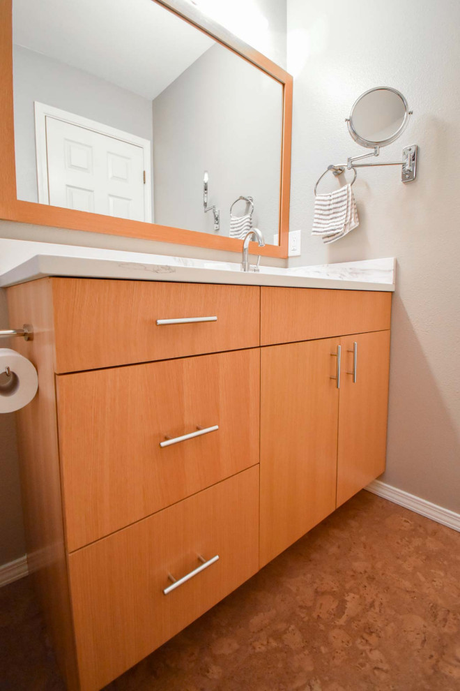 This is an example of a small modern 3/4 bathroom in Portland with flat-panel cabinets, light wood cabinets, a shower/bathtub combo, a two-piece toilet, white tile, subway tile, beige walls, cork floors, an undermount sink, engineered quartz benchtops, red floor, a shower curtain, white benchtops, a niche, a single vanity and a built-in vanity.