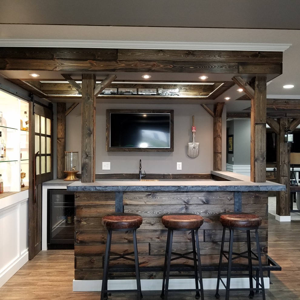 This is an example of a large arts and crafts u-shaped seated home bar in Minneapolis with medium wood cabinets, concrete benchtops, brown splashback, timber splashback, laminate floors and brown floor.
