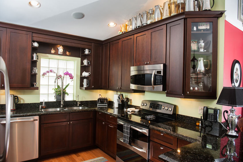 Inspiration for a large transitional u-shaped dark wood floor eat-in kitchen remodel in Miami with a double-bowl sink, shaker cabinets, dark wood cabinets, granite countertops, yellow backsplash, stainless steel appliances and no island