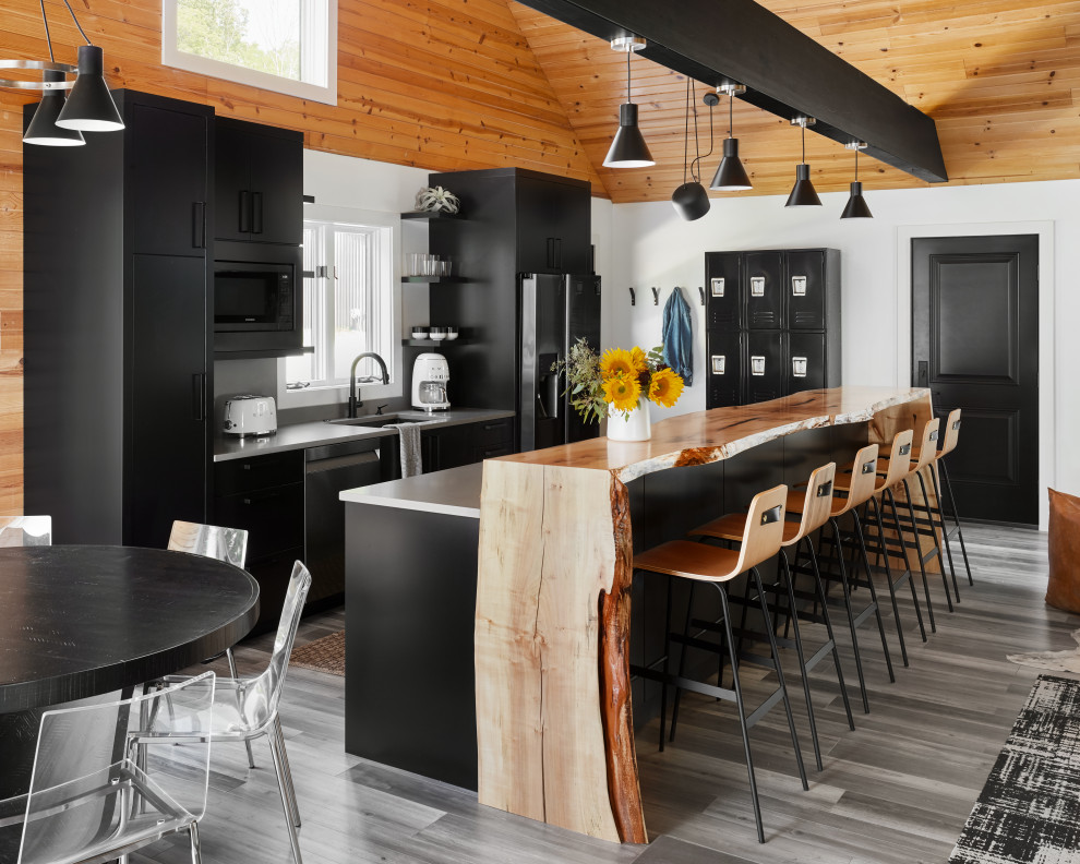 Design ideas for a country open plan kitchen in Chicago with an undermount sink, flat-panel cabinets, black cabinets, stainless steel appliances, with island, multi-coloured floor, grey benchtop, vaulted and wood.