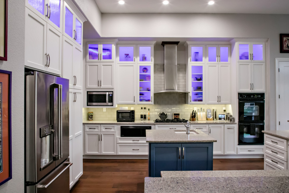 Photo of a large modern kitchen in Sacramento with white cabinets and an island.