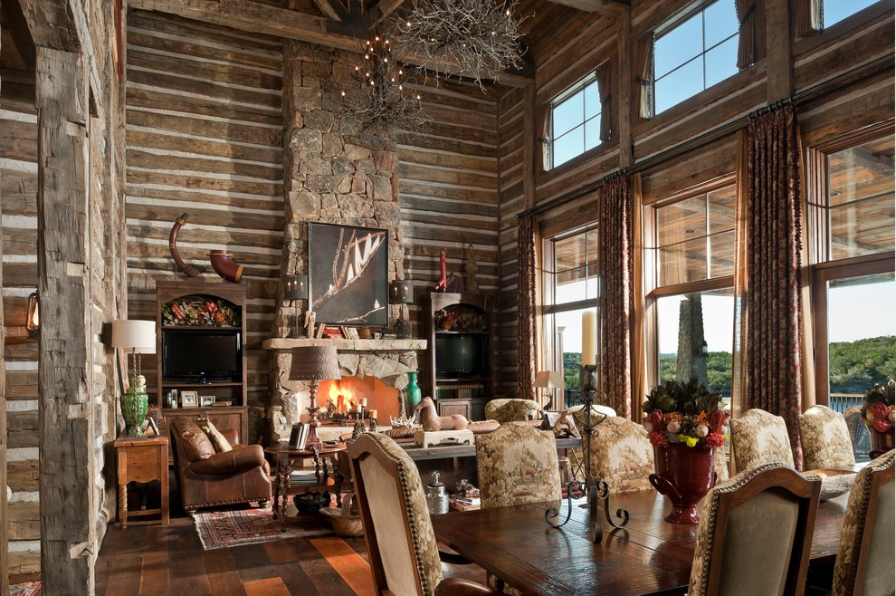 Inspiration for a mid-sized country formal enclosed living room in Dallas with brown walls, medium hardwood floors, a standard fireplace, a stone fireplace surround, no tv and brown floor.