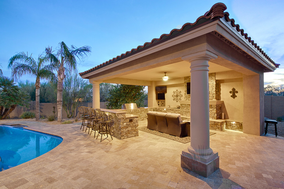 Photo of a large mediterranean backyard patio in Phoenix with concrete pavers.