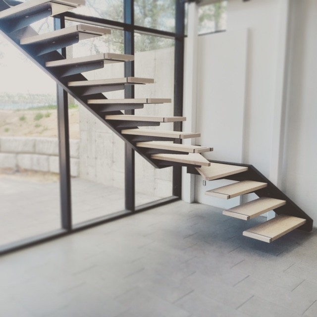 This is an example of a large contemporary wood floating staircase in Toronto with open risers.