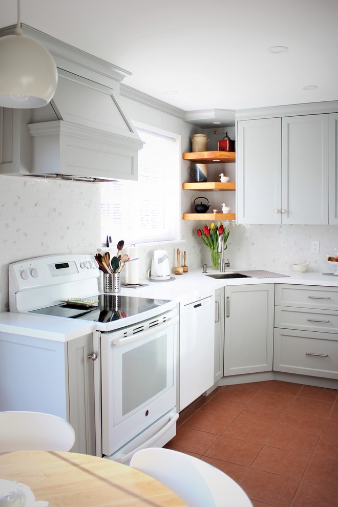Photo of a small transitional u-shaped eat-in kitchen in Toronto with an undermount sink, shaker cabinets, grey cabinets, quartz benchtops, white splashback, white appliances, terrazzo floors, red floor, white benchtop, no island and mosaic tile splashback.