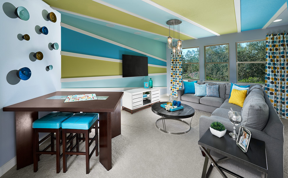 Photo of a mid-sized eclectic gender-neutral kids' room in Orlando with blue walls and carpet.