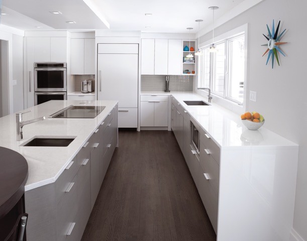 Inspiration for a large contemporary u-shaped kitchen pantry in New York with flat-panel cabinets, white cabinets, white splashback, stainless steel appliances, dark hardwood floors and with island.