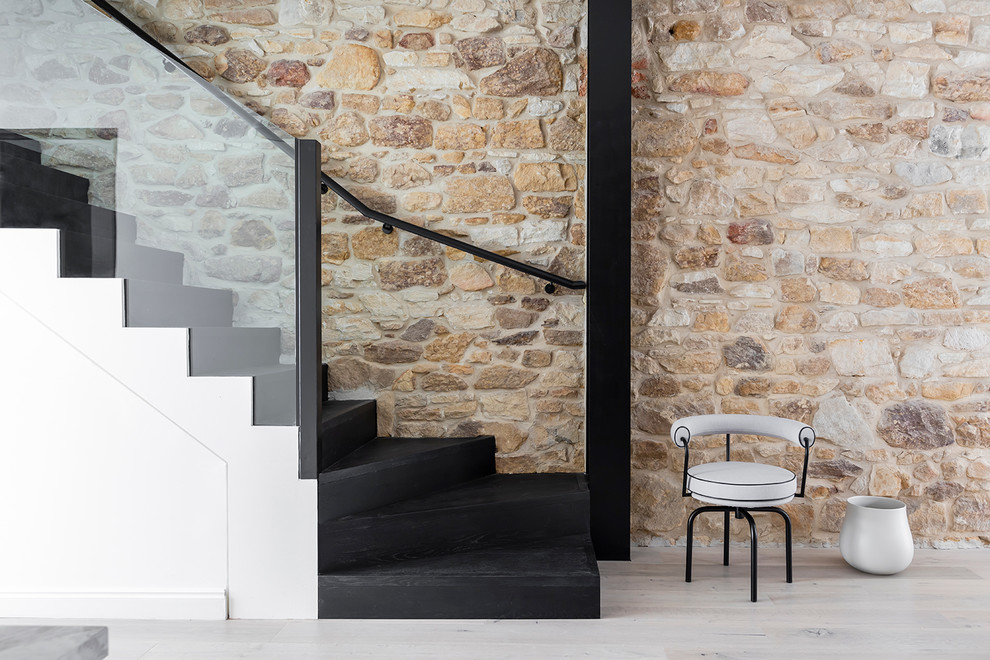 Photo of a contemporary wood curved staircase in Sydney with wood risers and glass railing.