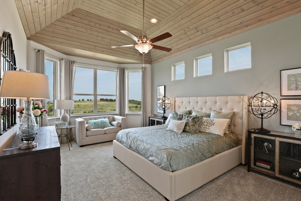 Photo of a large transitional master bedroom in Dallas with blue walls, carpet and beige floor.