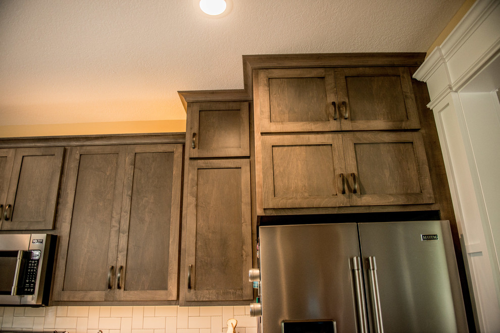 Inspiration for a large transitional l-shaped vinyl floor and multicolored floor open concept kitchen remodel with a farmhouse sink, shaker cabinets, gray cabinets, quartz countertops, white backsplash, subway tile backsplash, stainless steel appliances, an island and white countertops