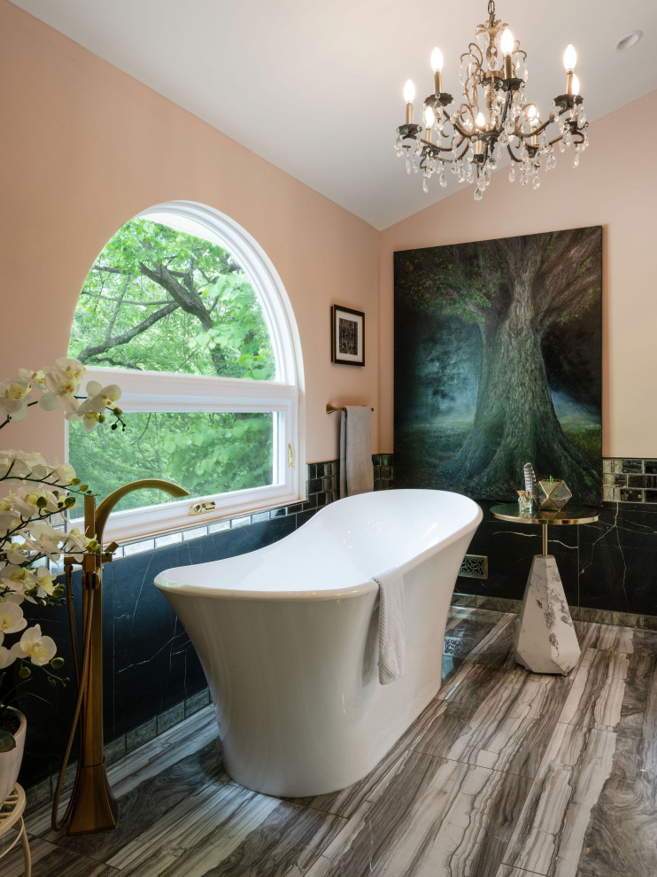 This is an example of a mid-sized master bathroom in Other with open cabinets, dark wood cabinets, a freestanding tub, a curbless shower, a two-piece toilet, black tile, marble, pink walls, ceramic floors, an undermount sink, marble benchtops, grey floor, a hinged shower door, white benchtops, a double vanity and a built-in vanity.