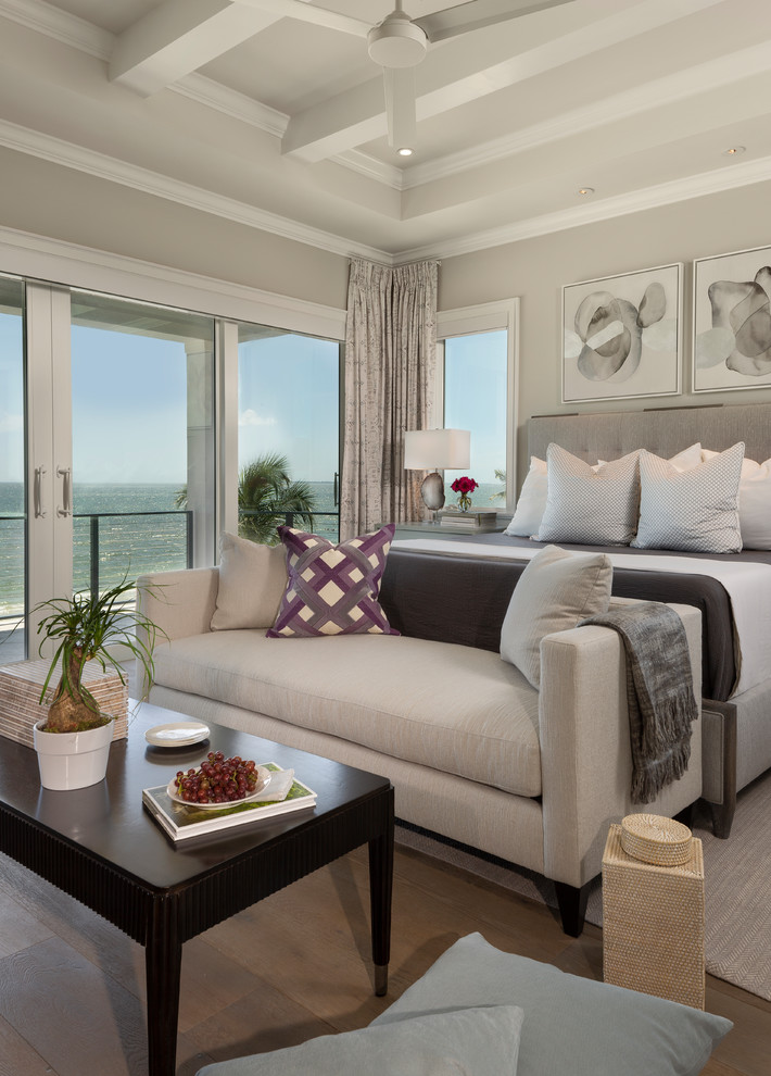 Photo of a mid-sized beach style master bedroom in Miami with grey walls, carpet, no fireplace and beige floor.