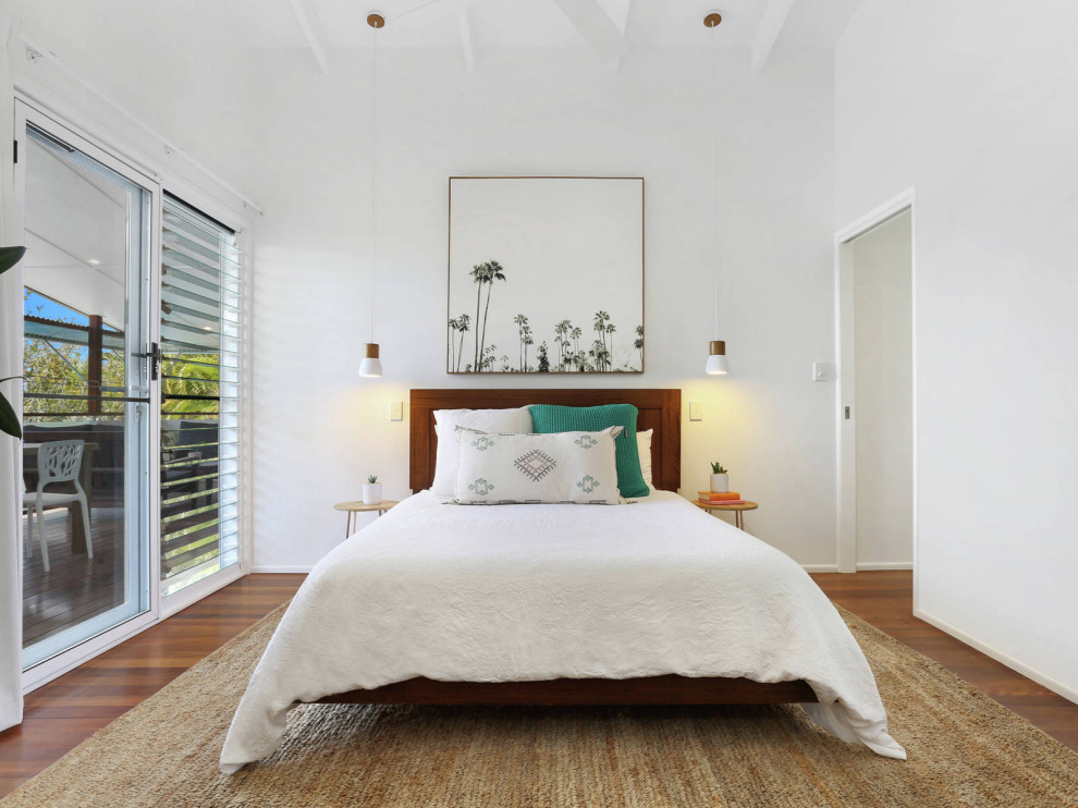 This is an example of a mid-sized beach style master bedroom in Sunshine Coast.