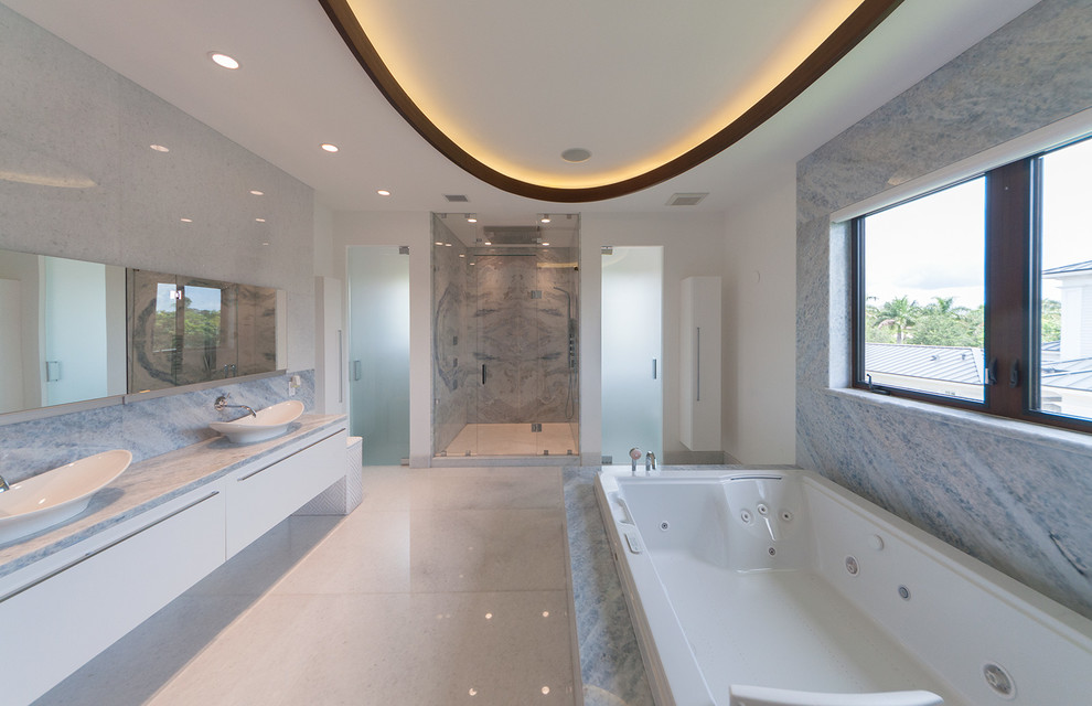 Large contemporary master bathroom in Miami with a wall-mount sink, flat-panel cabinets, white cabinets, a hot tub, an open shower, white tile, stone tile, quartzite benchtops, multi-coloured walls and marble floors.