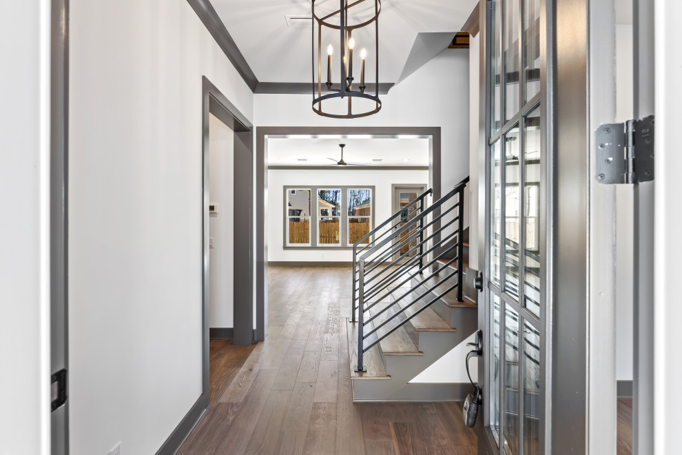 Foyer - mid-sized transitional dark wood floor and brown floor foyer idea with a gray front door