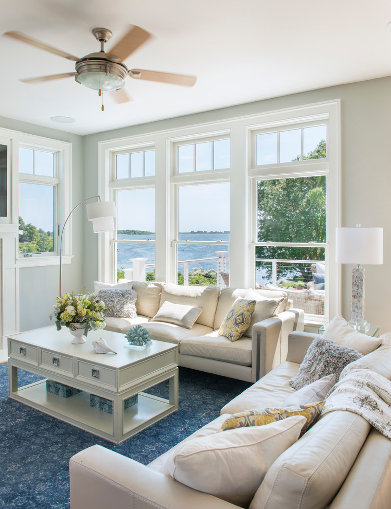 Small beach style open concept living room in Providence with grey walls, light hardwood floors, a standard fireplace and a stone fireplace surround.