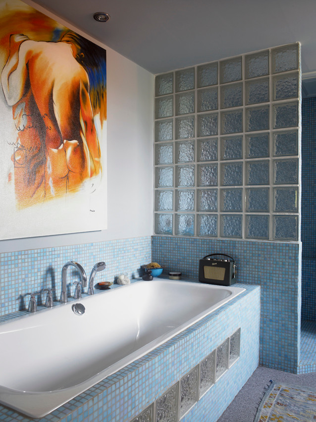 Inspiration for a large bohemian ensuite bathroom with a built-in bath, an alcove shower, a two-piece toilet, blue tiles, glass tiles, blue walls and a wall-mounted sink.
