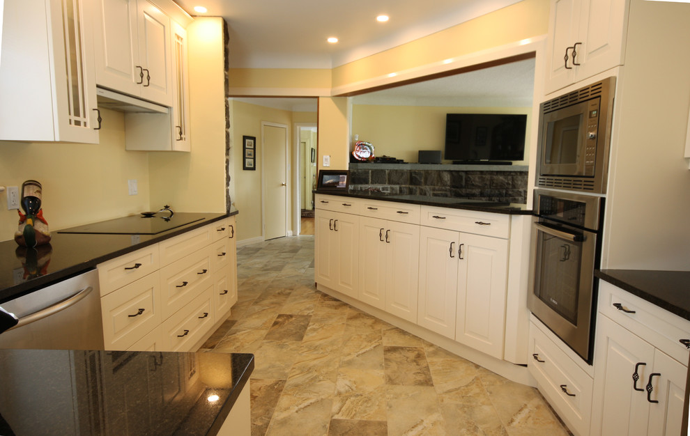 Small transitional porcelain tile kitchen photo in Ottawa with an undermount sink, raised-panel cabinets, white cabinets, granite countertops and stainless steel appliances