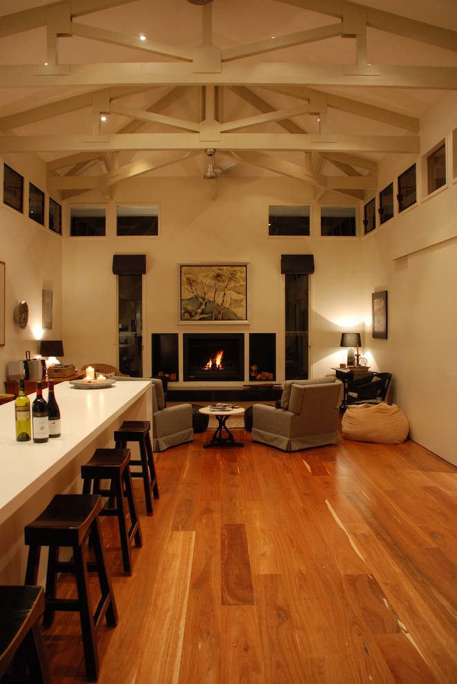 Design ideas for a mid-sized traditional galley kitchen in Geelong with a double-bowl sink, beige cabinets, laminate benchtops, beige splashback, ceramic splashback, stainless steel appliances, medium hardwood floors and with island.