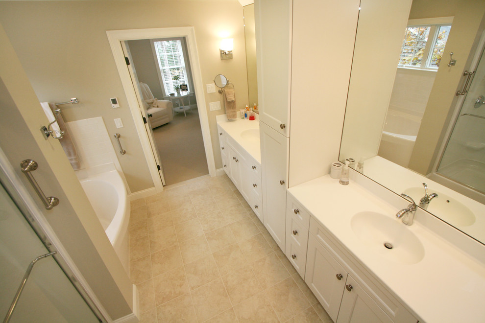 Photo of a beach style master bathroom in Boston with an integrated sink, recessed-panel cabinets, white cabinets, ceramic tile and ceramic floors.