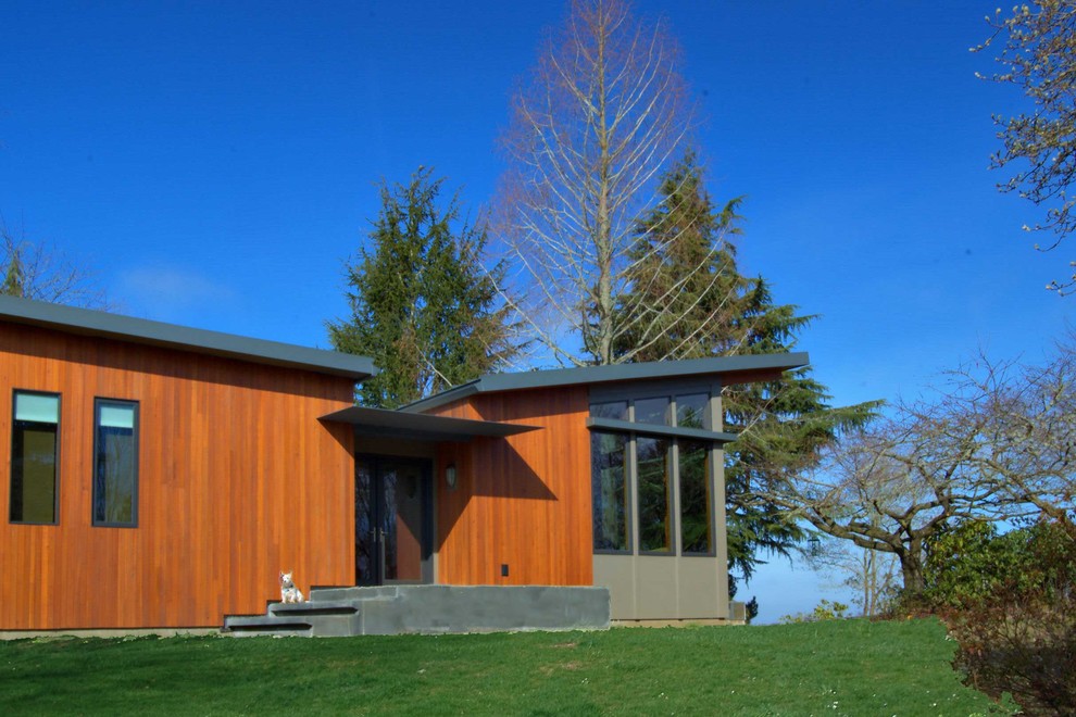 This is an example of a modern exterior in Portland with wood siding.