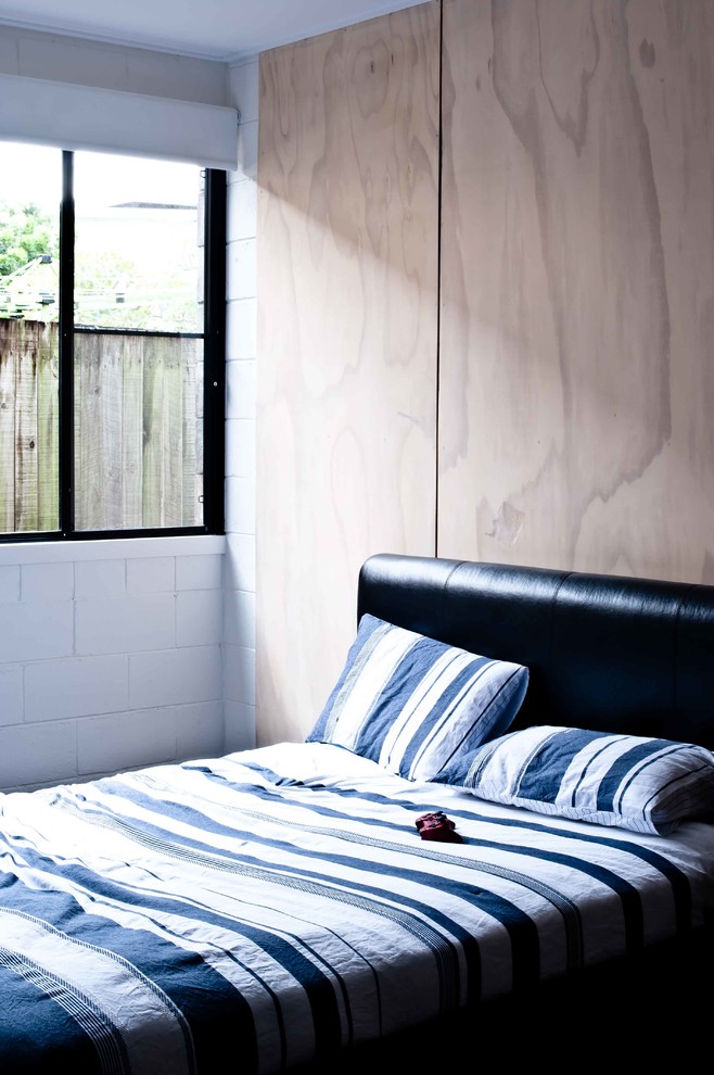 This is an example of a mid-sized industrial bedroom in Gold Coast - Tweed with concrete floors.