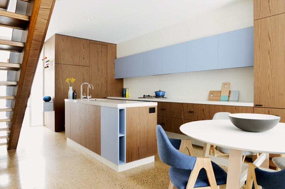 This is an example of a small modern galley open plan kitchen in Sydney with an undermount sink, flat-panel cabinets, medium wood cabinets, quartzite benchtops, white splashback, ceramic splashback, stainless steel appliances, concrete floors and with island.