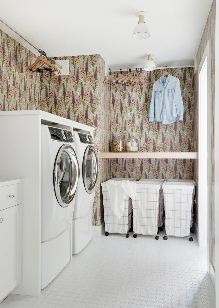 Photo of a country dedicated laundry room in Minneapolis with shaker cabinets, white cabinets, multi-coloured walls, a side-by-side washer and dryer, white floor and white benchtop.