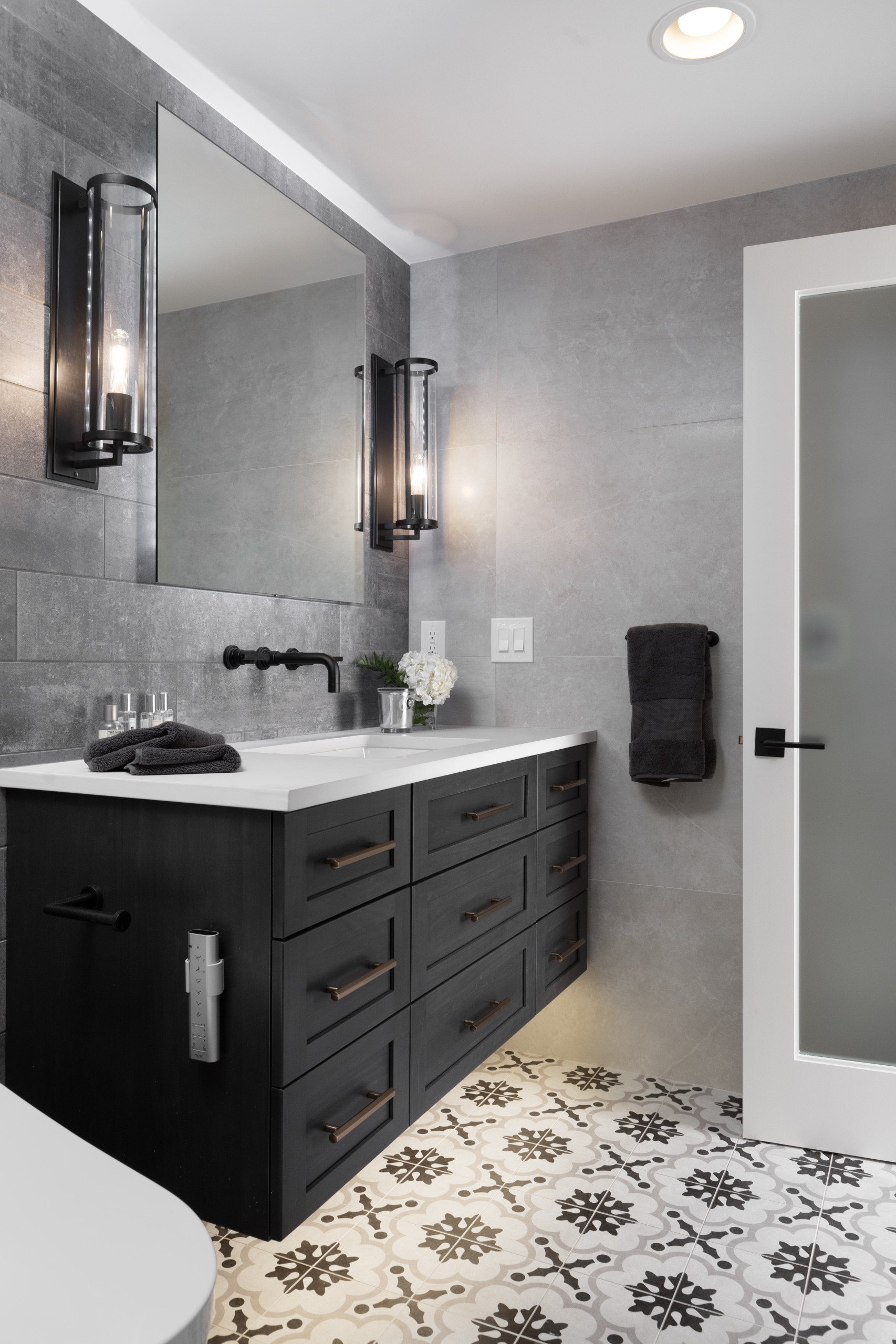Sauna - mid-sized industrial beige tile and porcelain tile porcelain tile and multicolored floor sauna idea in Detroit with shaker cabinets, black cabinets, a one-piece toilet, gray walls, an undermou
