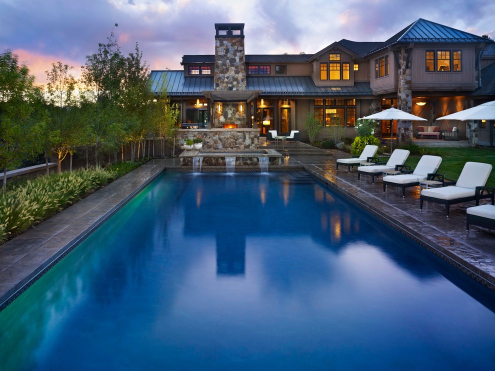 Contemporary rectangular lap pool in Denver with a water feature.