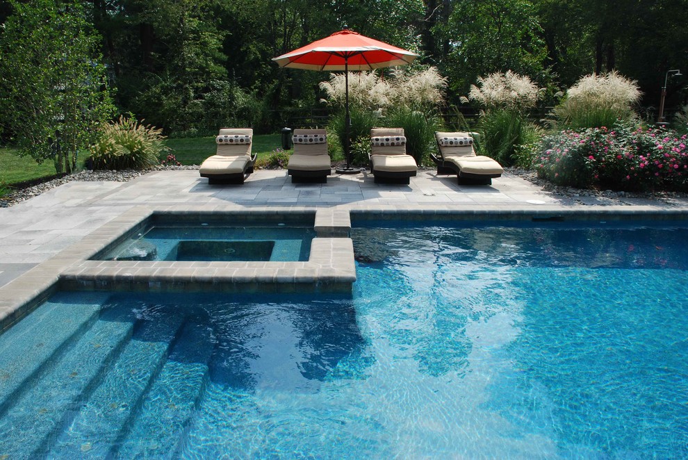 Mid-sized modern backyard rectangular pool in Philadelphia with a hot tub and concrete pavers.
