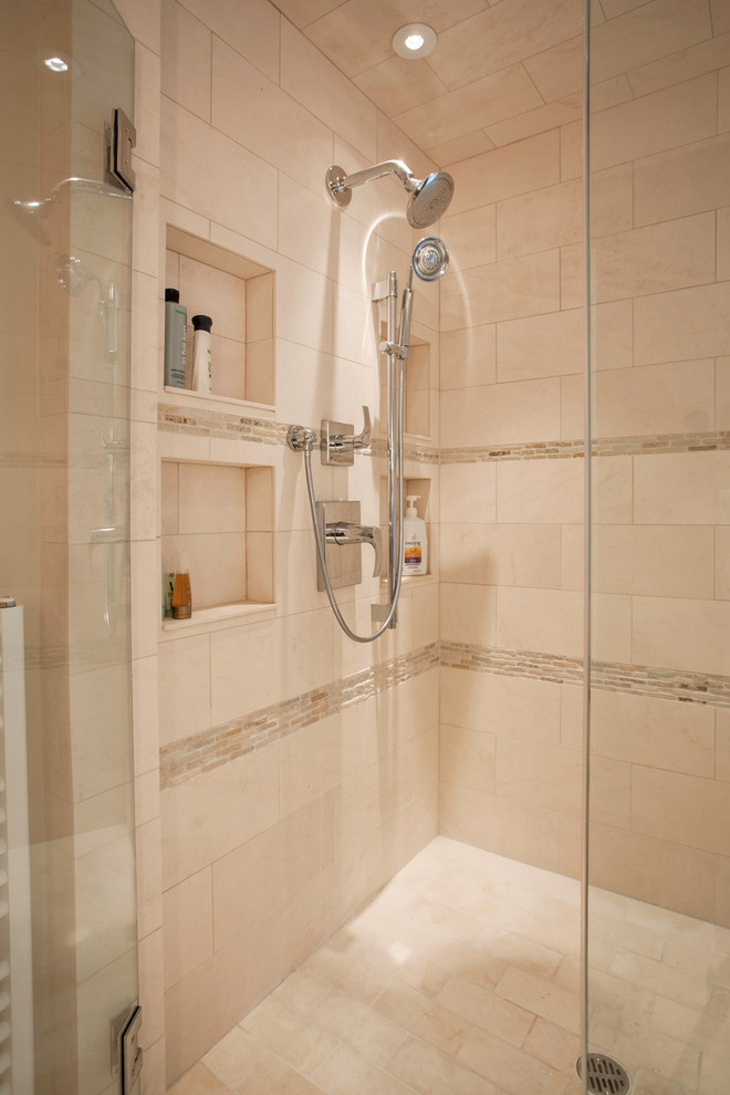 Photo of a mid-sized traditional master bathroom in Boston with flat-panel cabinets, medium wood cabinets, a freestanding tub, a corner shower, a one-piece toilet, beige tile, porcelain tile, beige walls, porcelain floors, an undermount sink and solid surface benchtops.