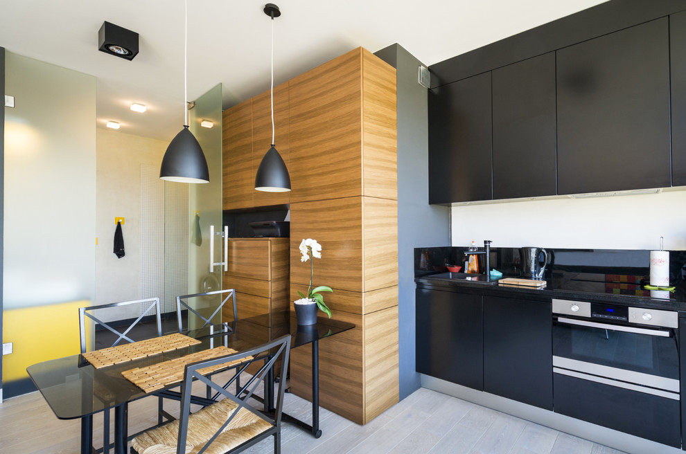 Design ideas for a mid-sized contemporary single-wall eat-in kitchen in Paris with black cabinets and no island.