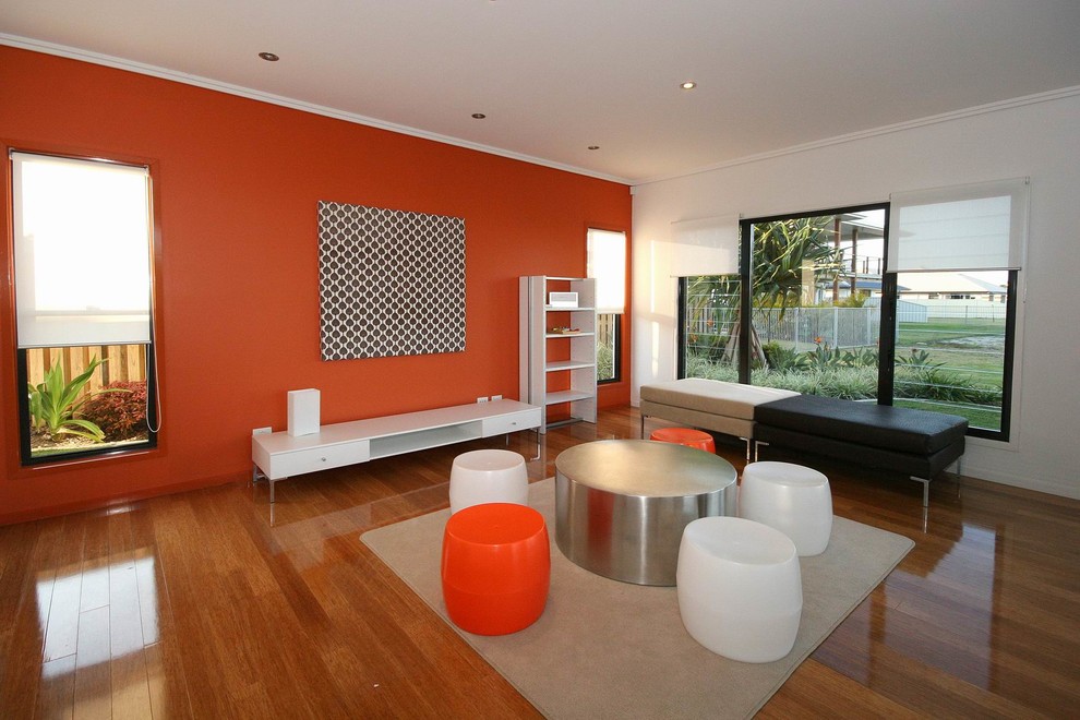 Photo of a large contemporary gender-neutral kids' playroom in Sunshine Coast with multi-coloured walls and medium hardwood floors.