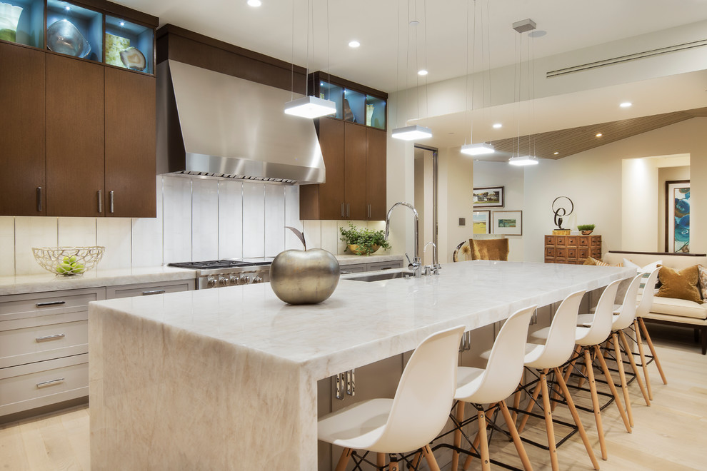 Design ideas for a contemporary galley kitchen in Orange County with an undermount sink, shaker cabinets, grey cabinets, white splashback, stainless steel appliances, light hardwood floors and with island.
