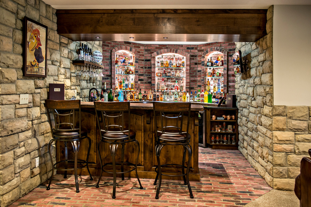 Inspiration for a mid-sized country u-shaped seated home bar in Kansas City with brick floors, red floor, dark wood cabinets, brown benchtop, an undermount sink, raised-panel cabinets and red splashback.